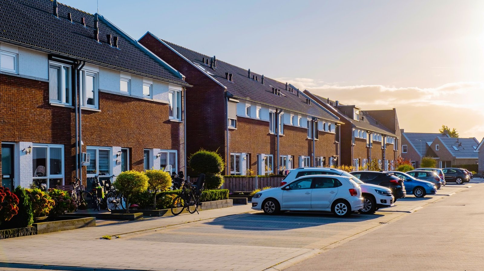 Modern terraced homes on a suburban street at golden hour